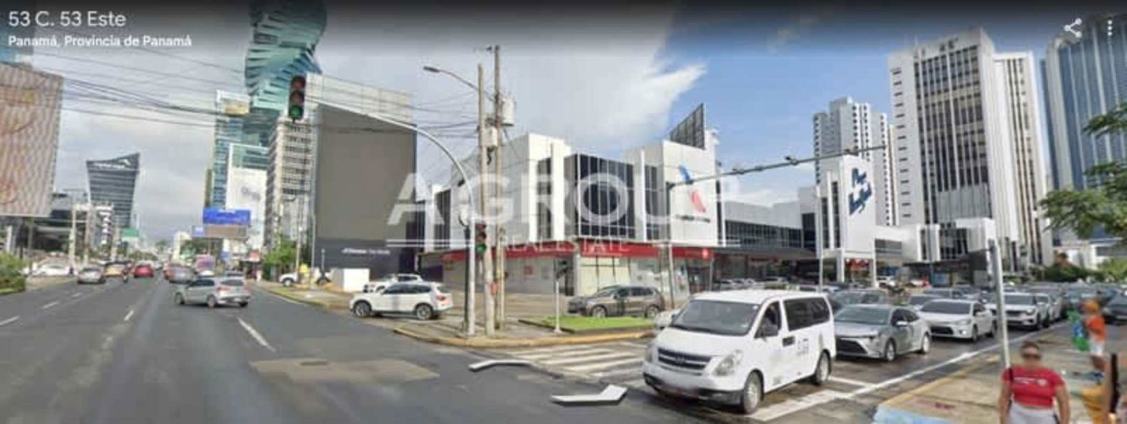 Busy Panama City street with commercial towers, storefronts and pedestrians near Plaza New York in Obarrio