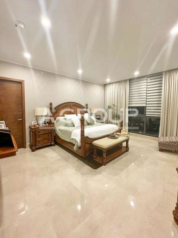 Spacious master bedroom with panoramic windows at Greenhouse Santa María Panama