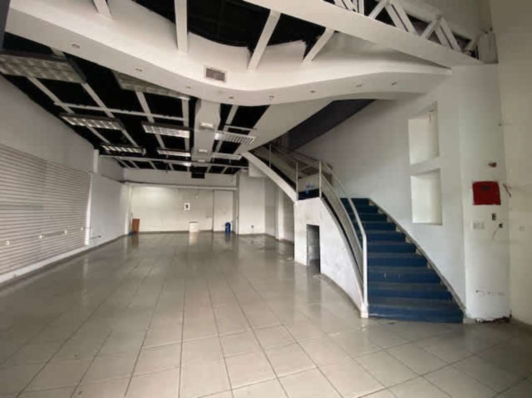 Exterior shopping plaza with parking spaces storefronts handicap parking spots at La Gran Estación San Miguelito Panama