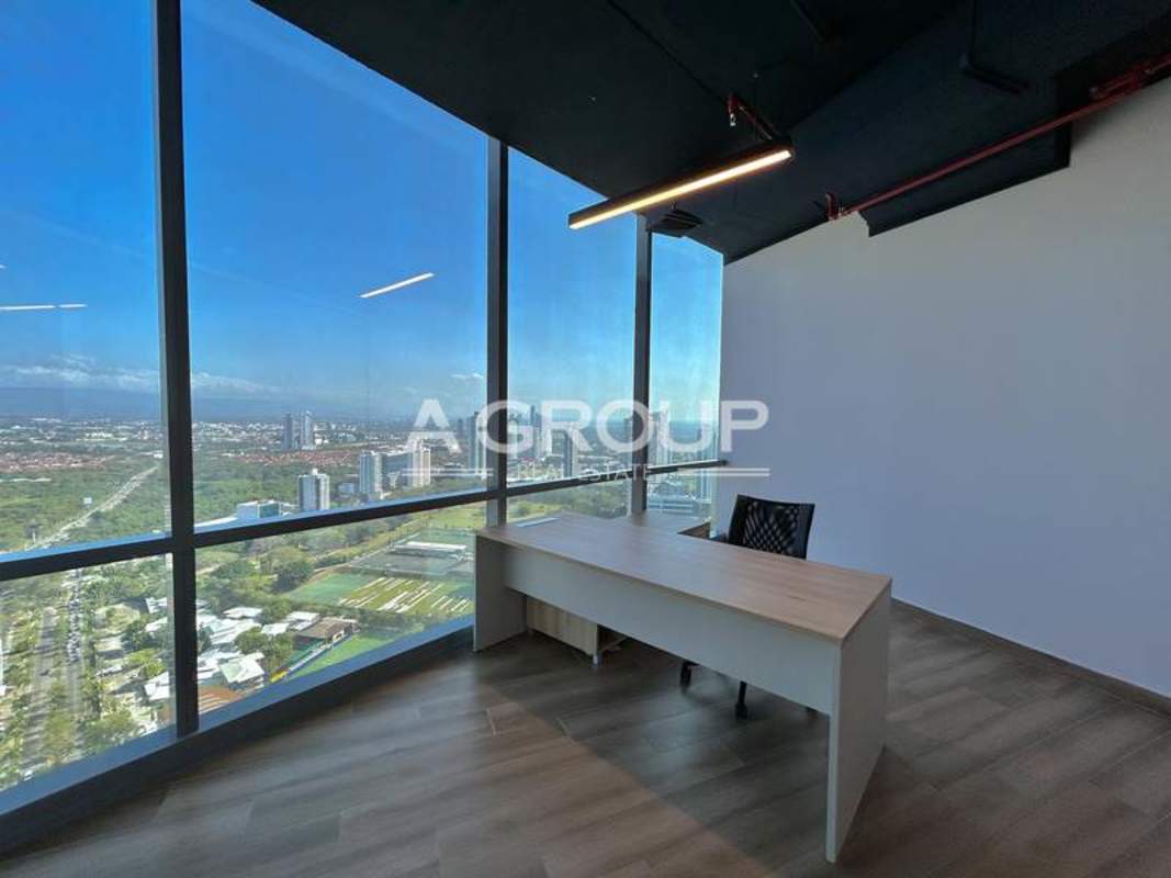 Private furnished office area with floor-to-ceiling windows overlooking city skyline at Financial Park Costa del Este
