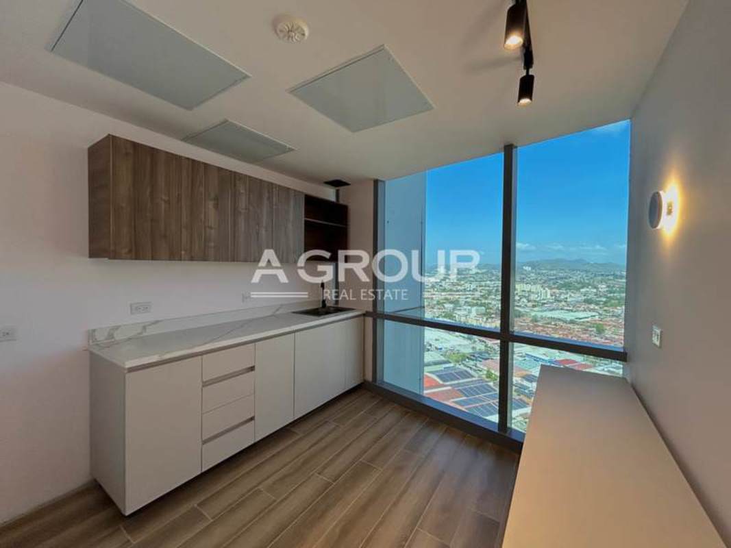 Modern kitchenette with large windows overlooking Costa del Este skyline Financial Park Tower Panama