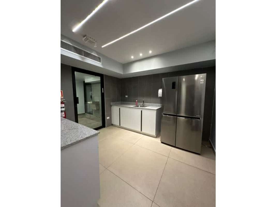 Open furnished corporate workspace with cubicles and glass partitions in PH World Trade Center Panama