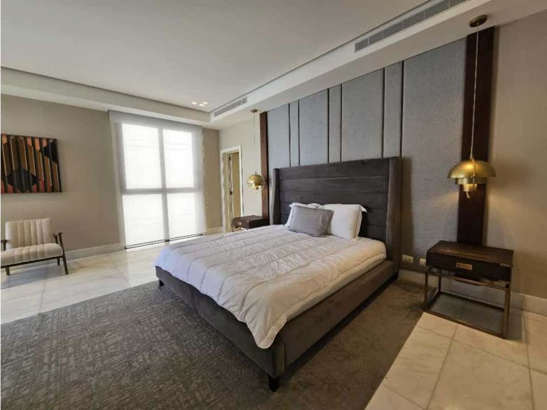 Modern bathroom with glass shower, marble walls and double sinks in Punta Pacífica apartment rental