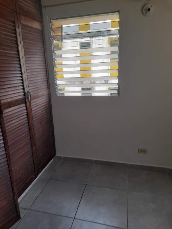 Empty bedroom with tile floor and louvered window Villa Gabriela Panama