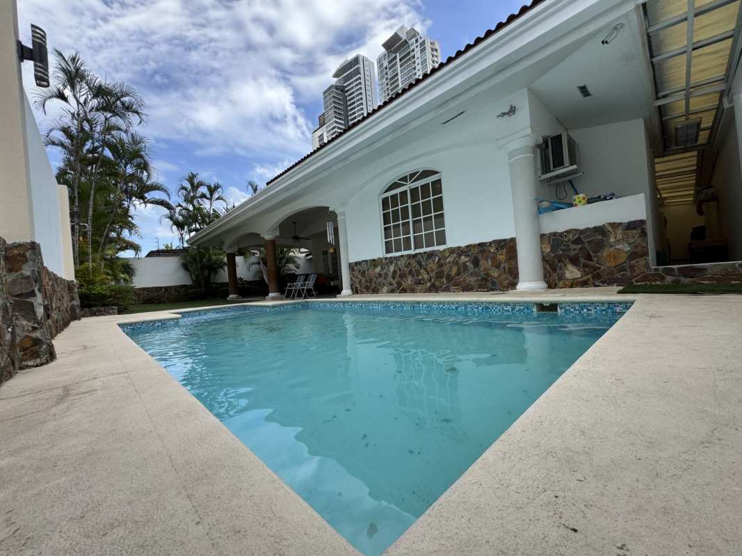 Mediterranean-style pool and patio with landscaping in Costa del Este Panama house