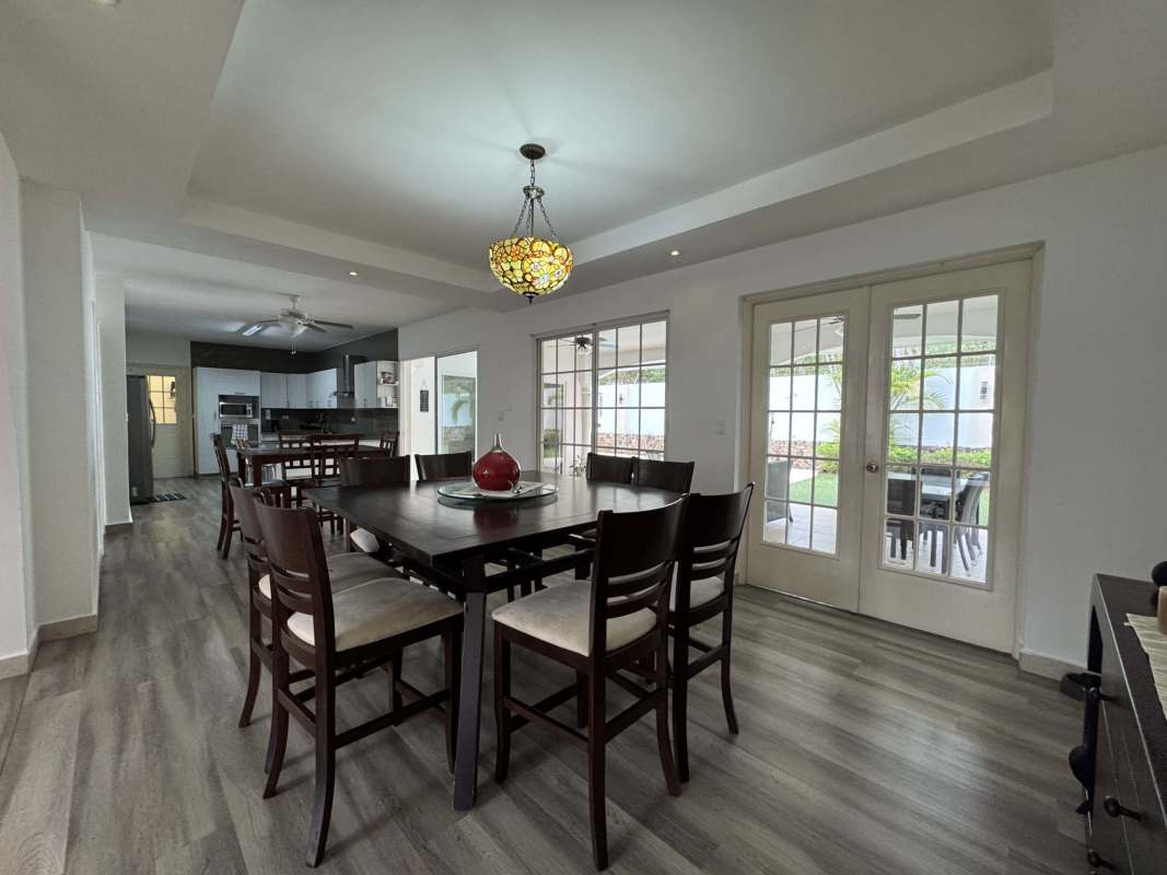 Family dining space adjoining kitchen with French doors in Costa del Este Panama