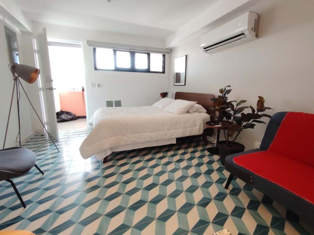 Bedroom corner of studio with AC, window, modern minimalist design Casco Viejo Panama