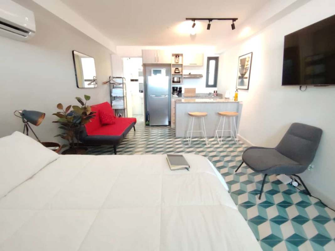 Compact American kitchen with granite counters, breakfast bar and appliances inside studio in Casco Antiguo Panama