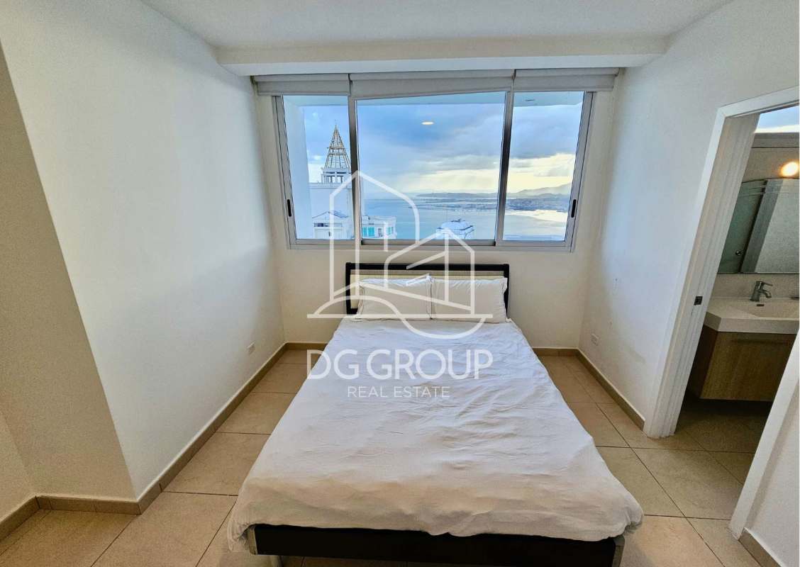 Bright open living dining room with balcony access and panoramic Pacific Ocean view in PH Oasis on the Bay Panama