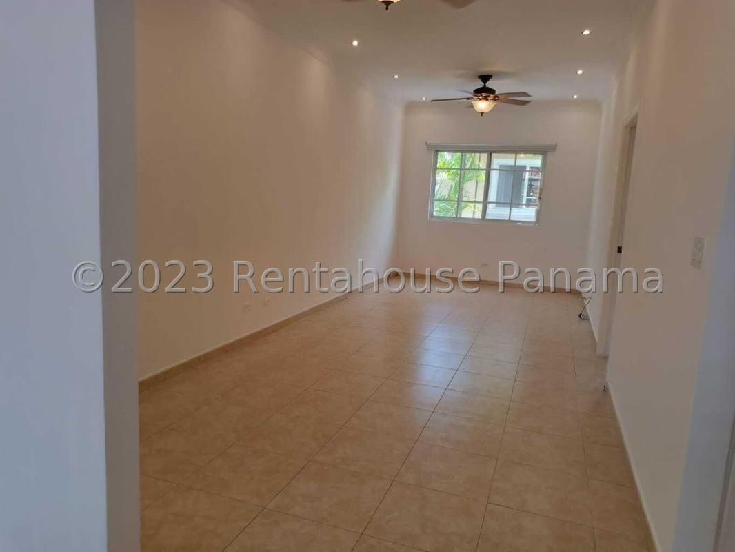 Elegant foyer with curved staircase iron rail and chandelier in Costa del Este house