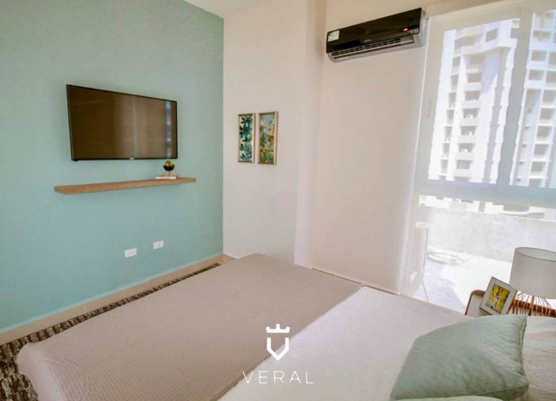 Bedroom space with large window, built-in closet and city view in new apartment PH Bella Veduta Panama