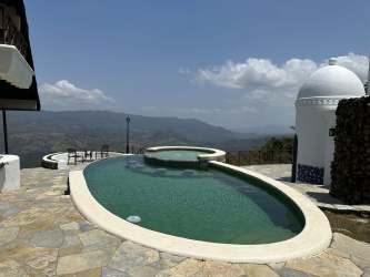 Living area with terracotta floor and rustic Mediterranean décor at Finca Naso Panama