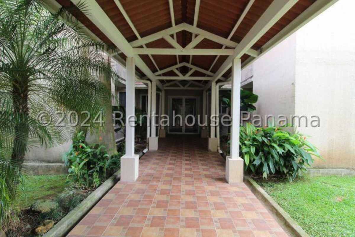 Security access and landscaped entrance to PH Torres de Versalles gated complex Panama City