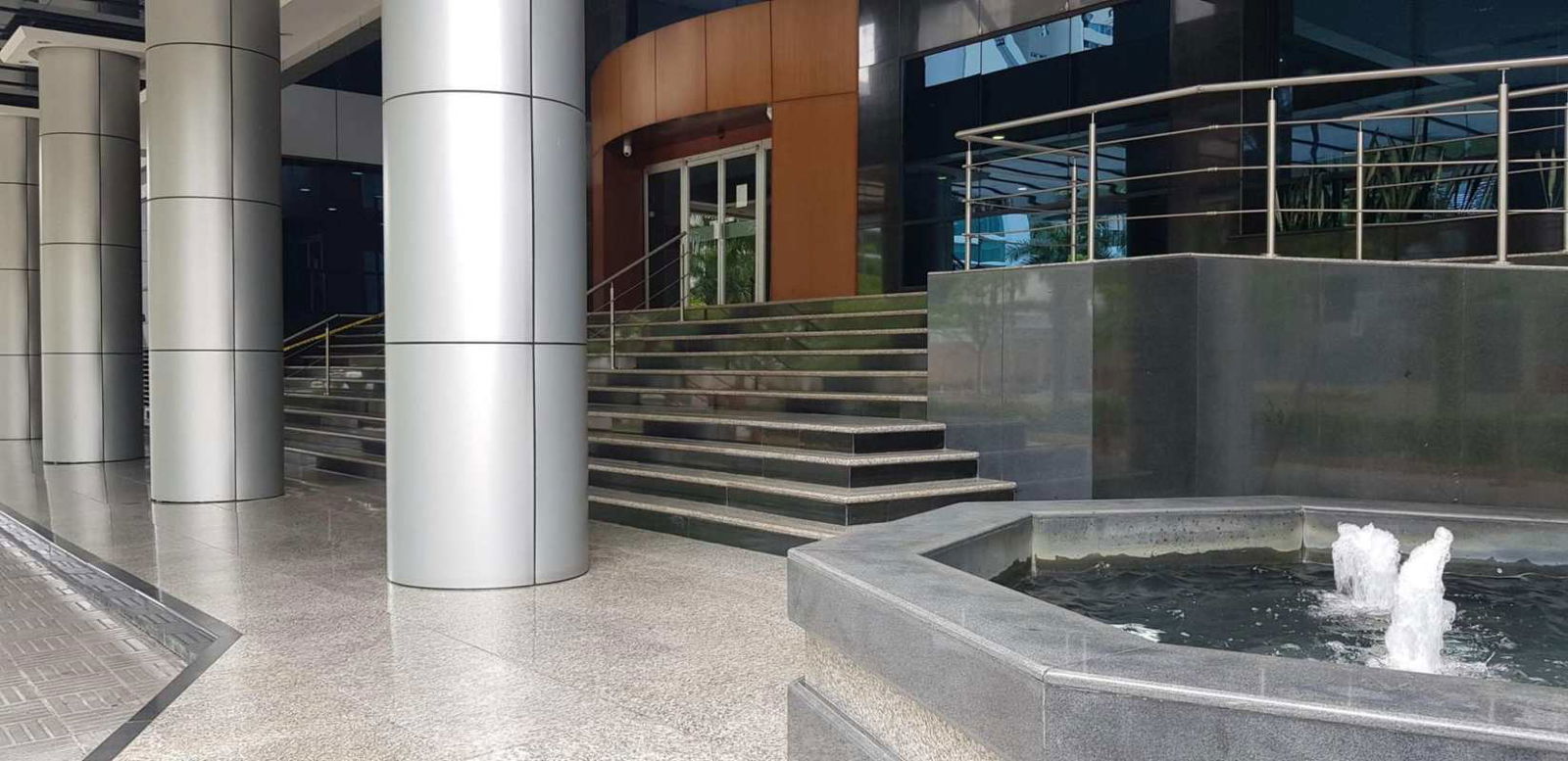 Stylish reception desk with accent ceiling and wood panel wall in Costa del Este Business Plaza Panama