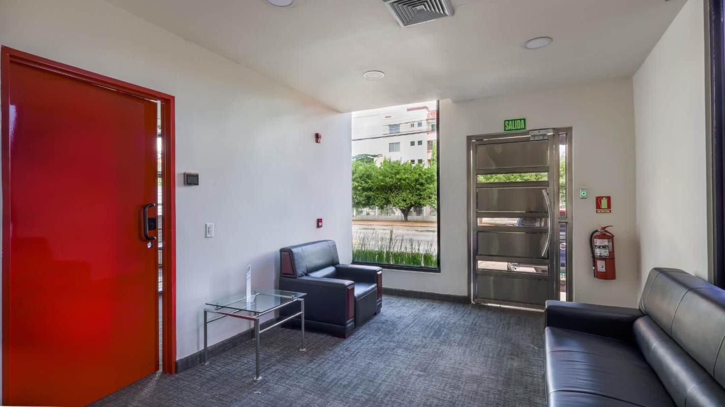 Lobby reception with leather sofas, emergency exit, black white decor Costa del Este Panama