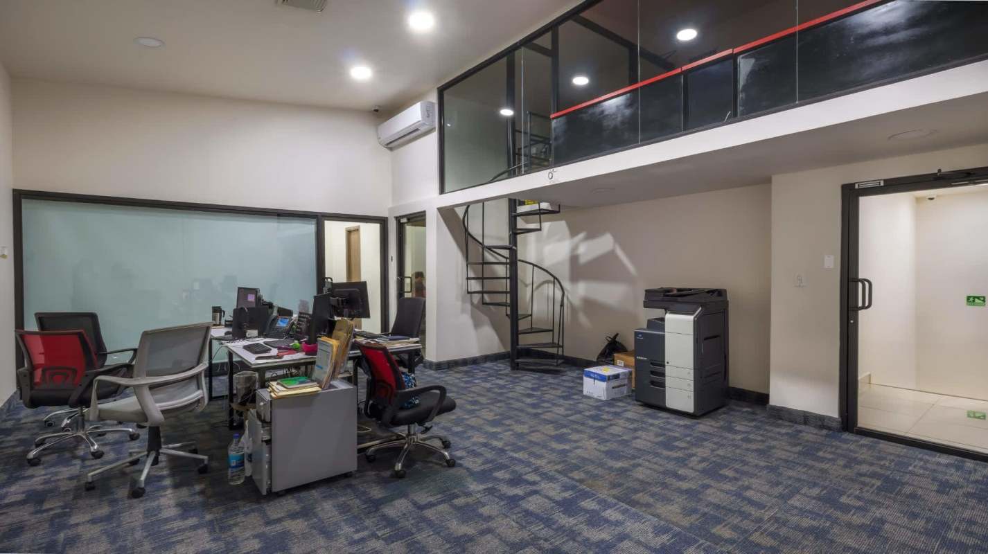 Private office with wood desk, leather chairs, blue carpet Costa del Este Panama