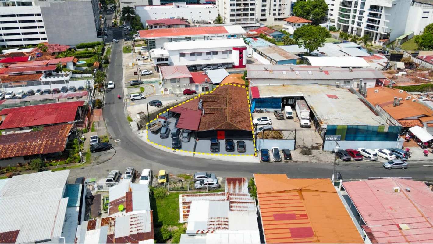 Aerial image of San Francisco commercial building with parking and red roof Panama City
