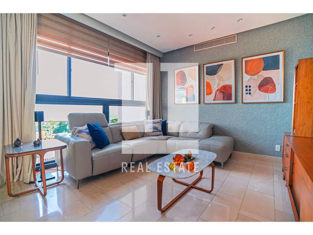 Modern kitchen with black granite countertops and stainless steel built-ins in Coco del Mar condo