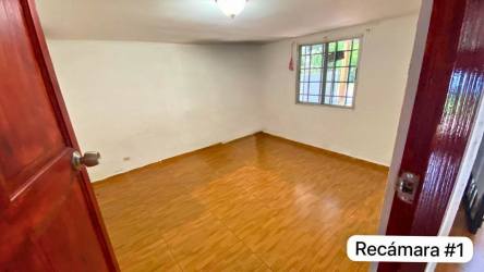 Bedroom with tile floor, window with bars in Ciudad del Futuro home Panama
