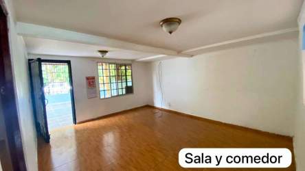 Iron gate with covered porch and garden area in Ciudad Futuro house Panama