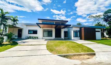 Modern single-level home exterior with landscaping at La Perla David