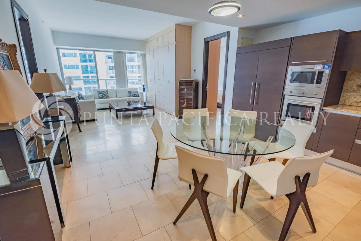 Bright living and dining area with large windows in luxury condo The Ocean Club Punta Pacifica Panama