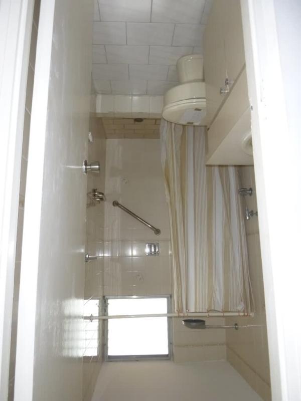 Traditional apartment kitchen with white cabinets, stainless refrigerator and gas stove PH Ocean View San Francisco