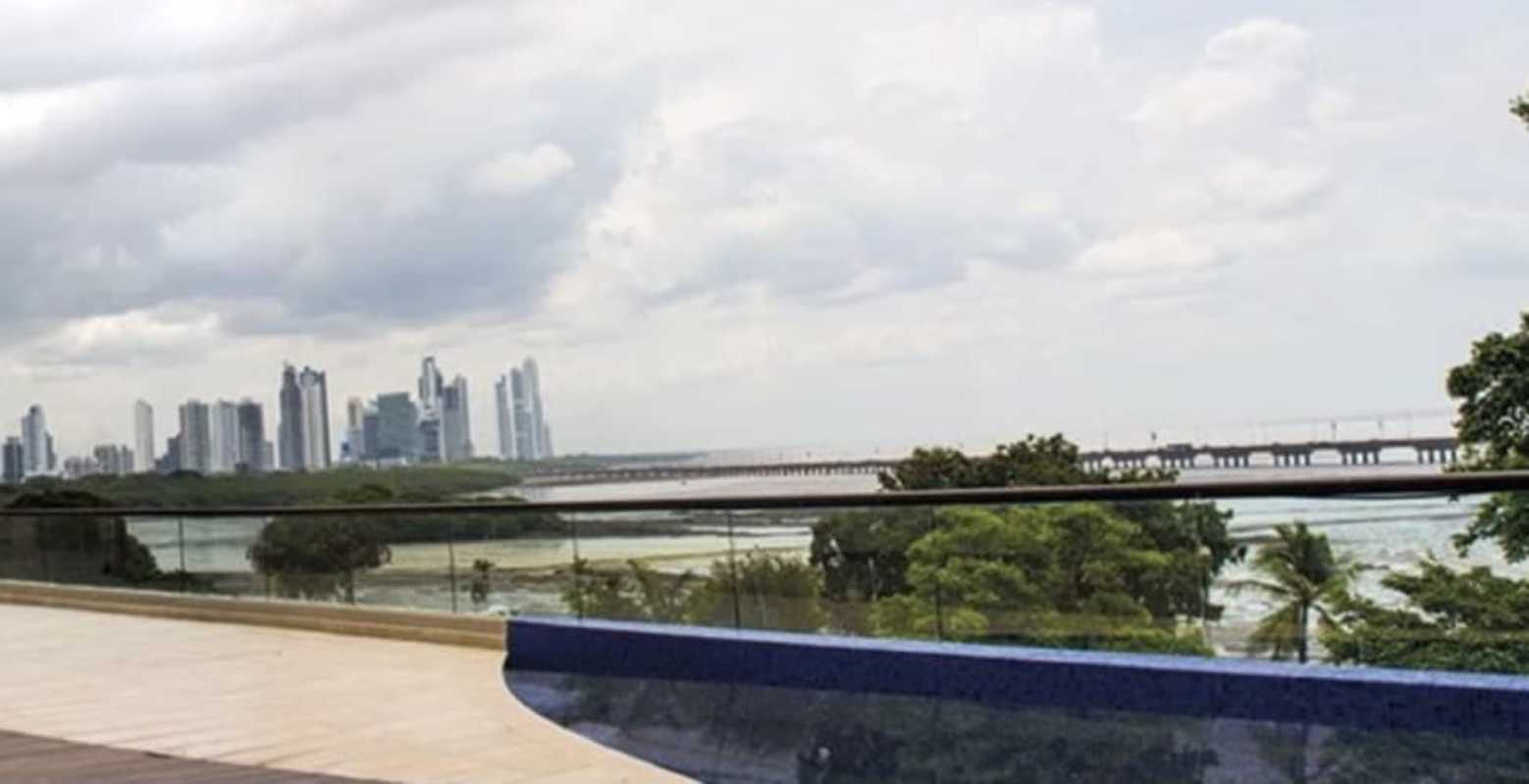 Private balcony with glass railing overlooking Pacific Ocean at PH Dal Mare Panama City