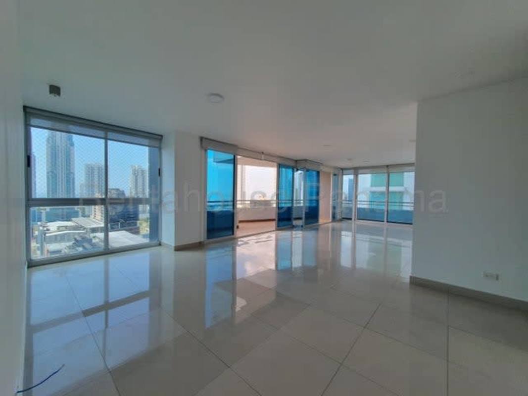 Living room with floor-to-ceiling windows panoramic city view at PH LaCosta Costa del Este Panama