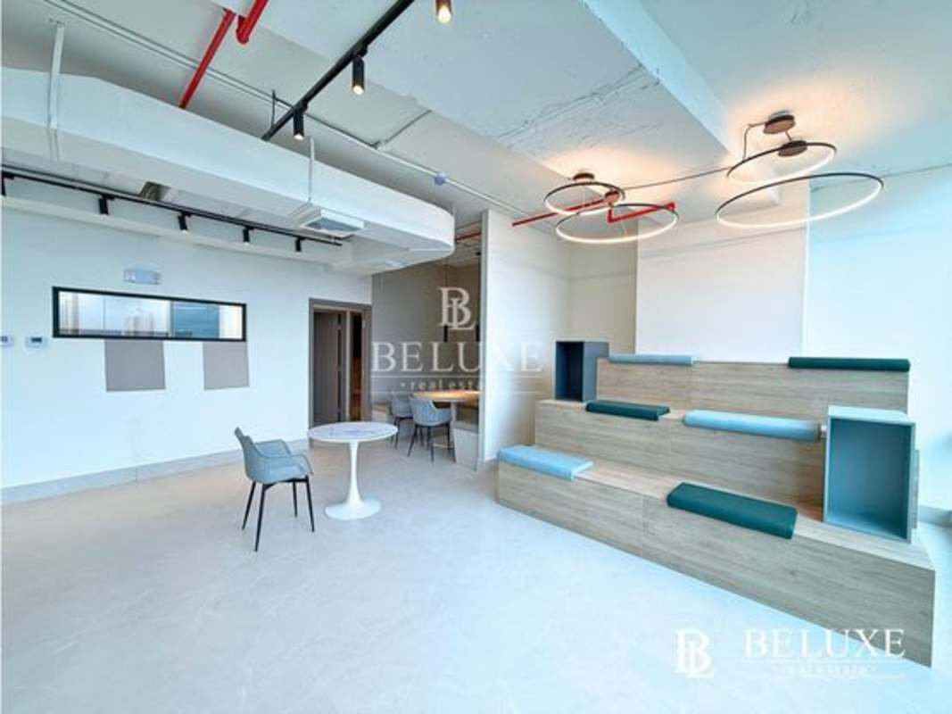 Open lounge workspace with wooden seating and exposed ceiling at Financial Park Costa del Este Panama