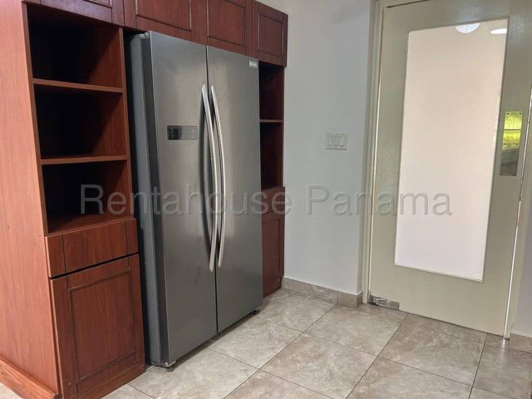 Spacious bedroom with large window and bathroom Embassy Gardens house Panama