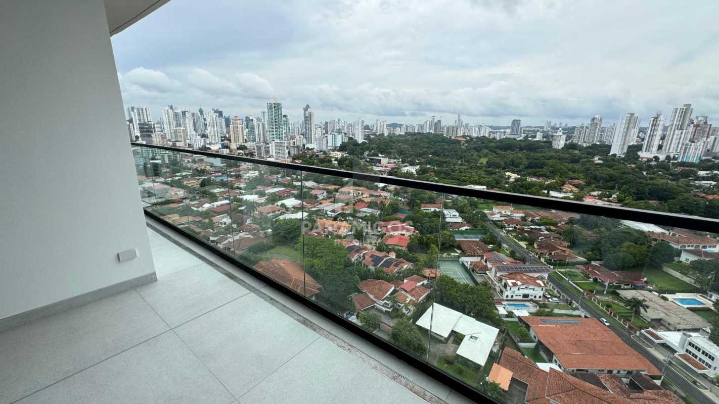 Spacious balcony with glass railing overlooking Pacific Ocean and Panama skyline at PH Victory Wellness