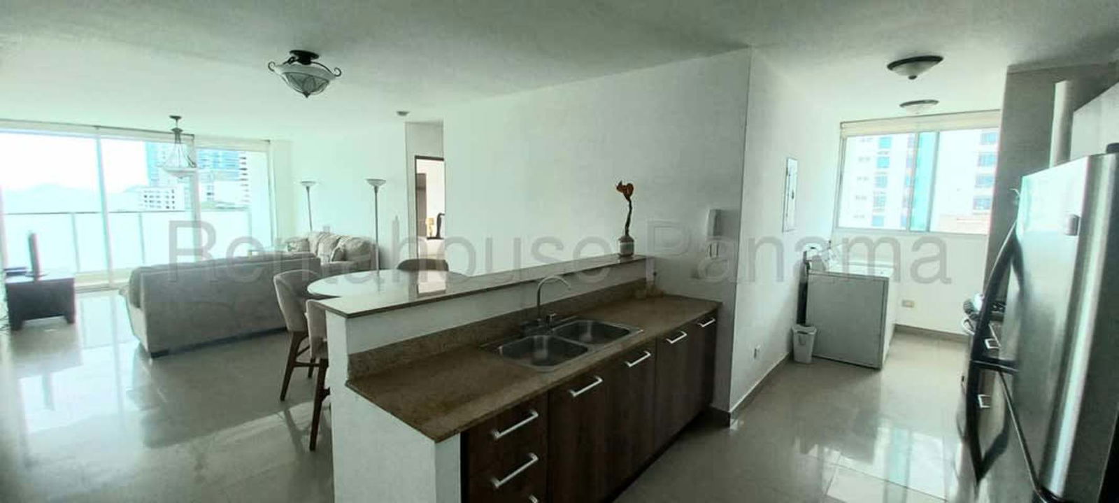 Modern kitchen with granite countertops, breakfast bar, natural light at PH Pacific Sea in Punta Pacifica Panama City