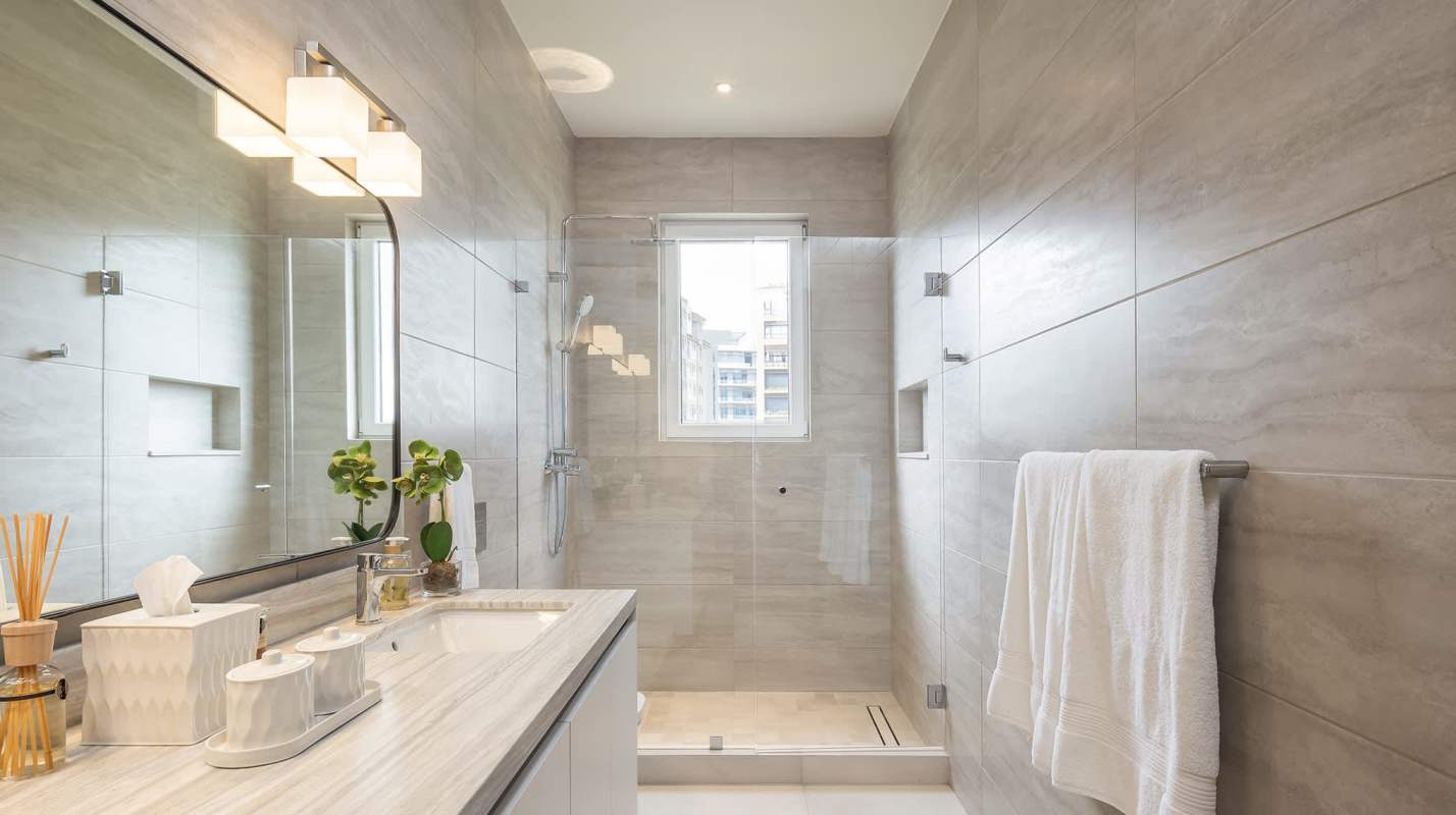 Bright bathroom with glass shower and designer fixtures in luxury home Santa María Golf Panama