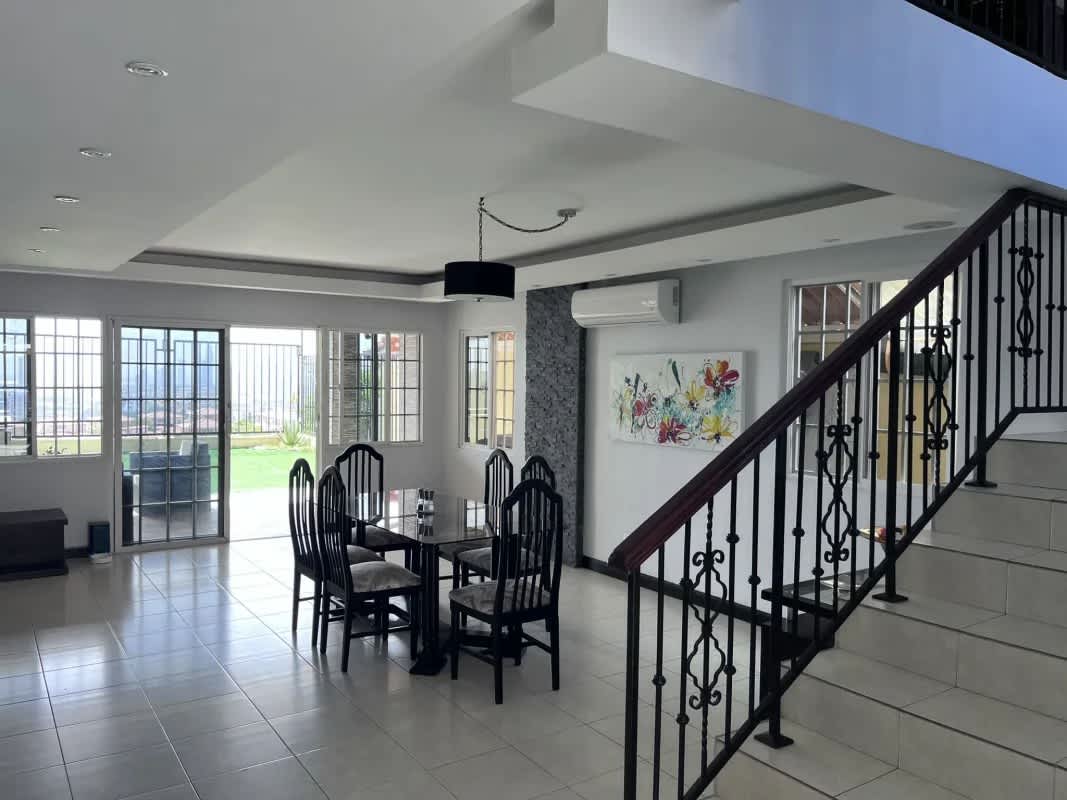 Large living room with tile floor ceiling fans and accent wall in Panama Villa Lucre house for sale