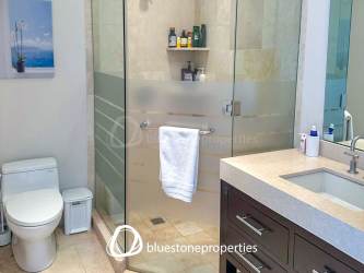 Contemporary bathroom with glass-enclosed shower and modern fixtures at penthouse in Buenaventura Panama