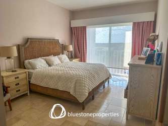 Luxury bedroom with private balcony access and ocean views in penthouse Panama beach condo