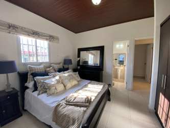 Bright open-plan kitchen with granite counters and dining area inside Americans style house in Boquete Panama