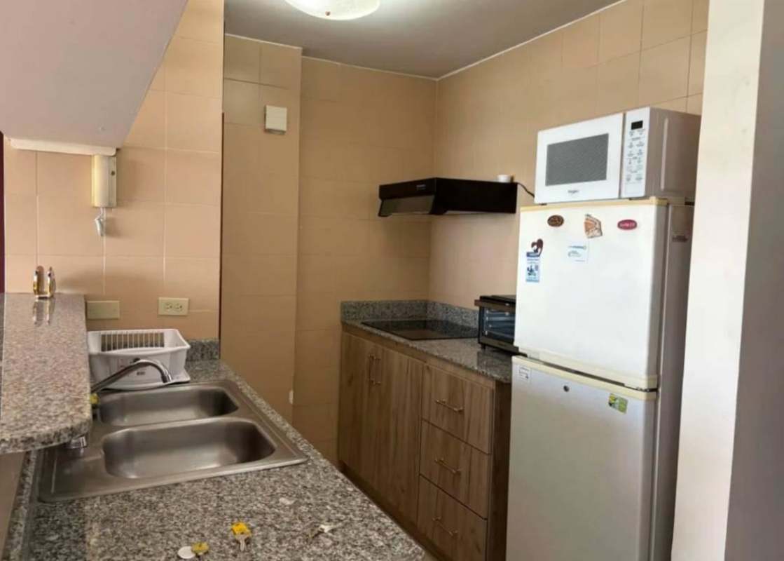 Modern kitchen with granite counters, microwave, refrigerator in PH BICSA Panama City
