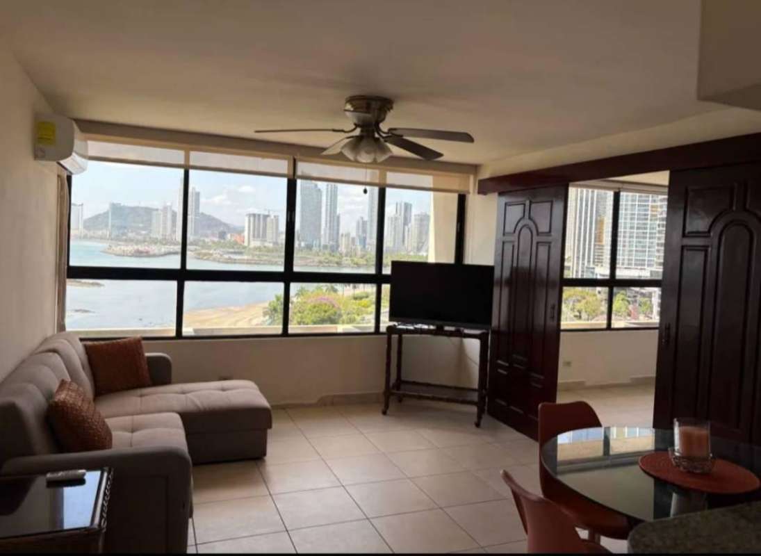 Open-plan dining and living space with scenic city views at PH BICSA apartment Panama