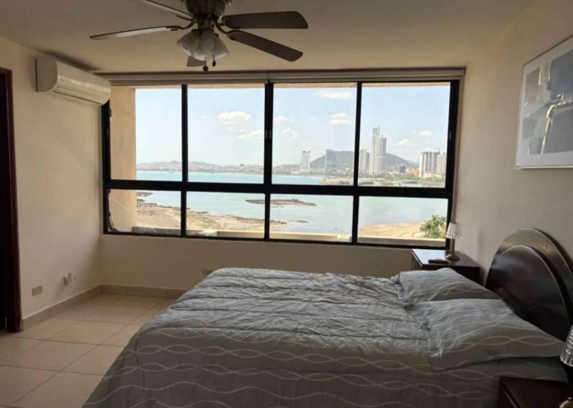 Bright bedroom with ocean & skyline view, ceiling fan, AC in PH BICSA Financial Center