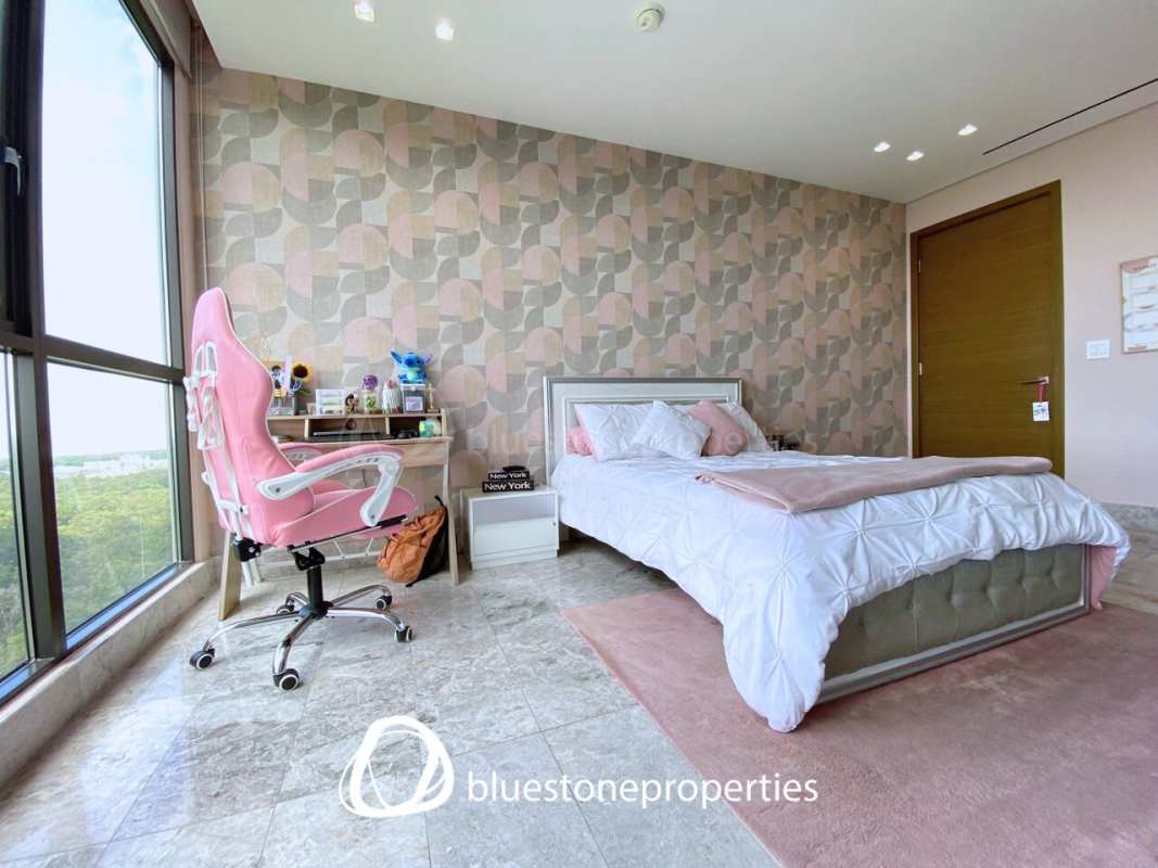 Spacious master bedroom with large windows, marble floors, walk-in closet and ocean view balcony at Empire Residences Panama