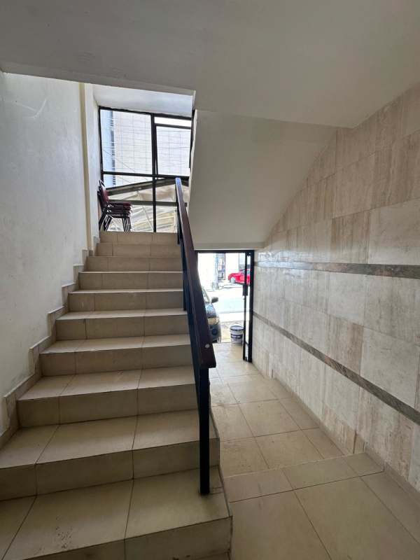 Indoor staircase with tiled walls and windows at Edificio Dervio San Francisco Panama investment building