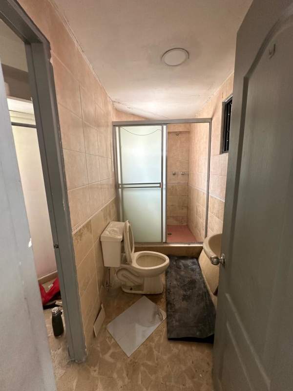 Bathroom with blue and white tiles, glass block window inside apartment Edificio Dervio San Francisco Panama