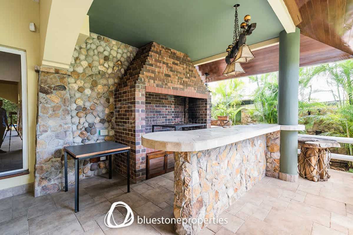 Backyard with swimming pool, palm trees, landscaped gardens Altos del Golf luxury house Panama