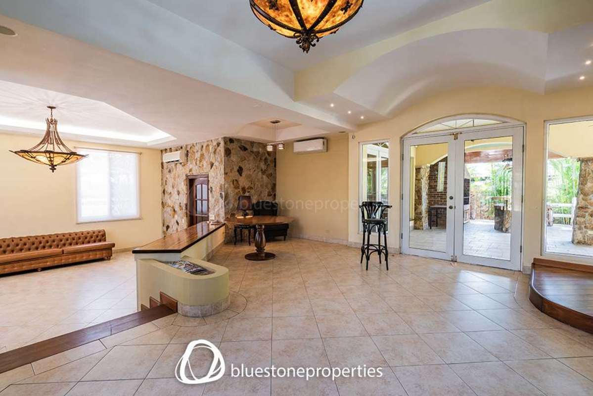 Elegant large open plan space with stone wall, glass doors to patio in Altos del Golf Panama