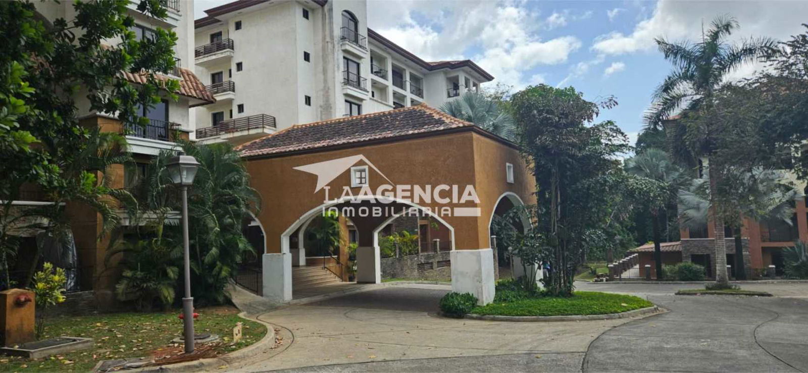 Bright living dining room with large windows and forest-view balcony Embassy Club Clayton Panama