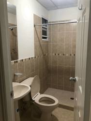 Bathroom with beige ceramic tiles, walk-in shower, and sink La Arboleda Los Avellanos Puerto Caimito La Chorrera Panama