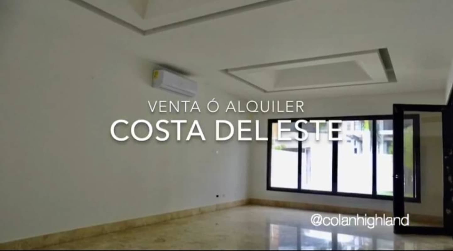 Large open living room with marble floors and tall windows in luxury Costa del Este home