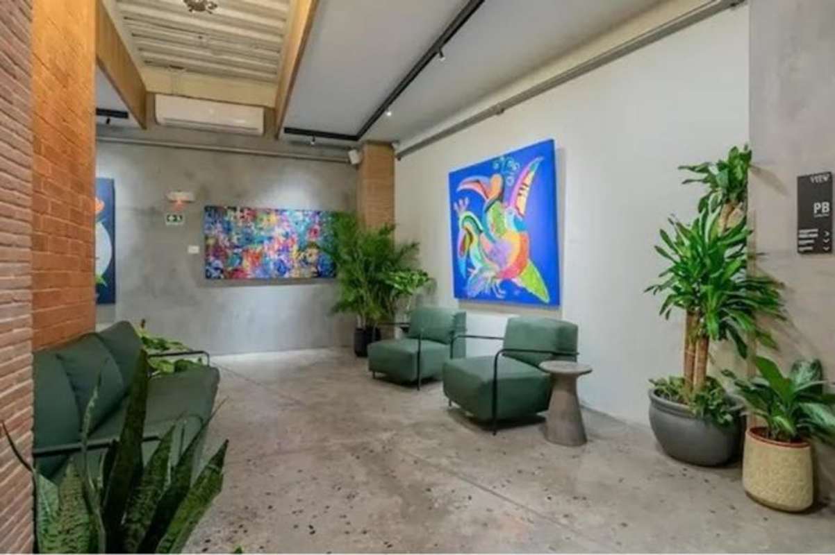 Living room with large windows, greenery decor, Panama skyline at PH Casco View Casco Viejo